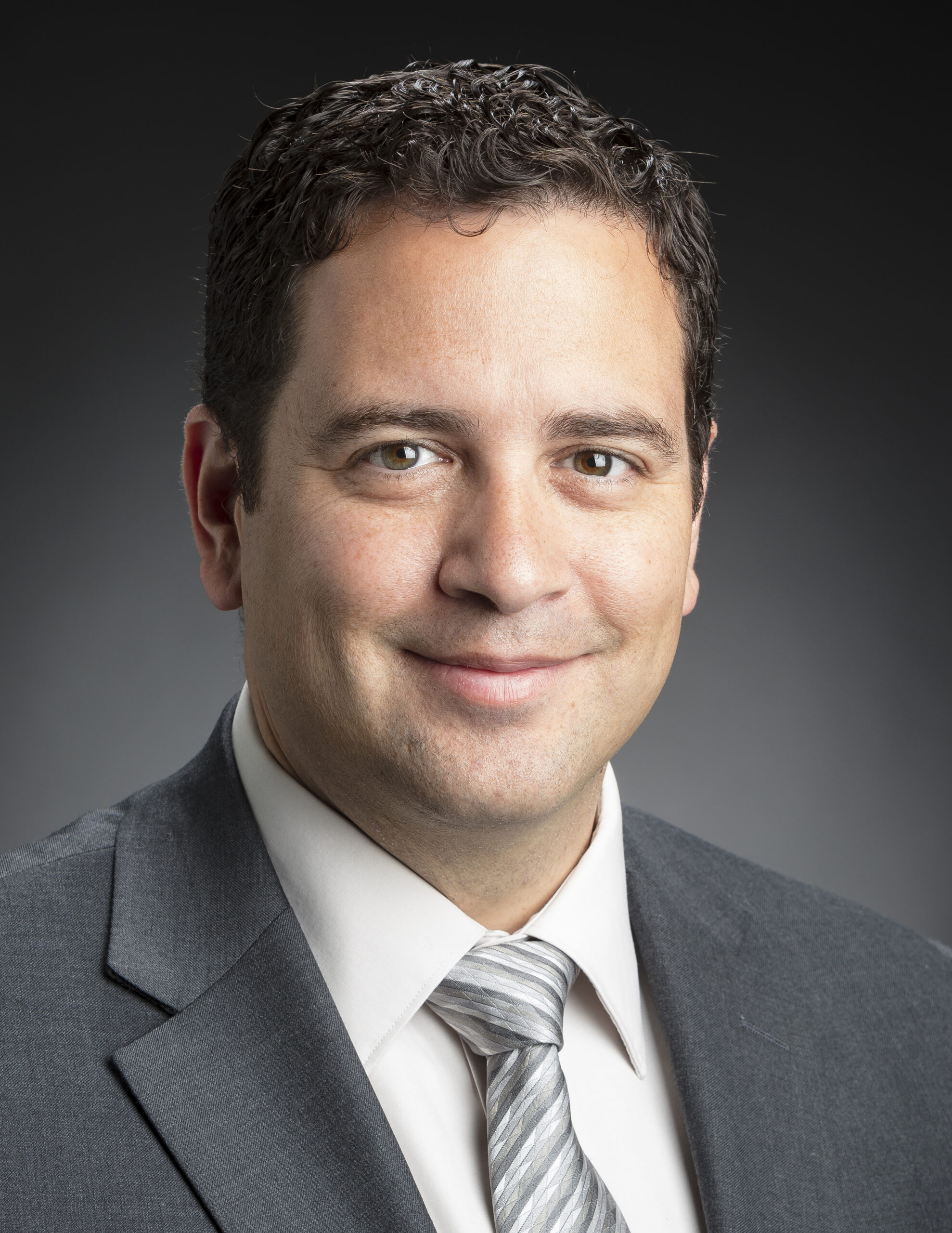 Profile photo of Kevin Ligozio in a grey suit with tie
